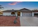 Charming single story home with a two-car garage and well-manicured landscaping at 3701 W Phelps Rd, Phoenix, AZ 85053