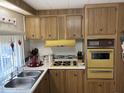 Retro kitchen with yellow appliances and double sink at 4065 E University Dr # 140, Mesa, AZ 85205