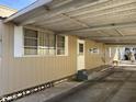 Side view of mobile home showing carport and entrance at 5201 W Camelback W Rd # D69, Phoenix, AZ 85031