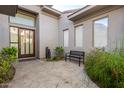 Private courtyard with a bench, small fountain, and lush landscaping at 10975 E Greenway Rd, Scottsdale, AZ 85255