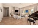 Living room with fireplace, hardwood floors, and plenty of natural light at 10975 E Greenway Rd, Scottsdale, AZ 85255