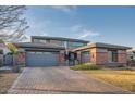 Two-story home with brick accents and a three-car garage at 4566 N Golf Dr, Buckeye, AZ 85396