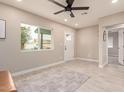 Bright living room with tile floors and ceiling fan at 6119 W Orangewood Ave, Glendale, AZ 85301