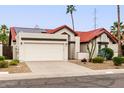 Single-story home with red tile roof, solar panels, and desert landscaping at 11085 E Becker E Ln, Scottsdale, AZ 85259