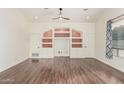 Bright living room with built-in shelving and hardwood floors at 14604 N 100Th Pl, Scottsdale, AZ 85260