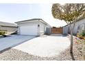 View of garage and gated side yard with gravel at 18157 W Foothill Dr, Surprise, AZ 85387