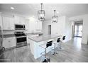 Open concept kitchen with island, stainless steel appliances, and granite countertops at 18157 W Foothill Dr, Surprise, AZ 85387
