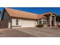 House exterior showcasing a two-car garage and desert landscaping at 2854 E Mallory St, Mesa, AZ 85213