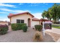 Tan house with red tile roof and attached garage, for sale sign at 5203 E Saguaro Cir, Phoenix, AZ 85044