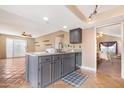Island kitchen with granite countertops and dark cabinets at 5203 E Saguaro Cir, Phoenix, AZ 85044