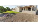 Backyard view showing a grassy area and a gravel pathway at 635 S 79Th Pl, Mesa, AZ 85208