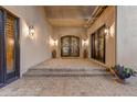 Brick walkway leads to the house entrance with double doors and lighting at 9749 N Fireridge Trl, Fountain Hills, AZ 85268