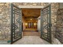 Ornate metal gates open to a grand entryway with a tile floor at 9749 N Fireridge Trl, Fountain Hills, AZ 85268