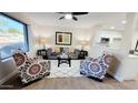 Spacious living room with large window and ceiling fan at 2064 S Farnsworth Dr # 18, Mesa, AZ 85209