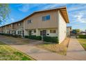 Row of tan townhomes with walkways and landscaping at 2449 W Missouri Ave, Phoenix, AZ 85015