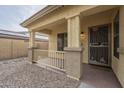 Covered porch with decorative metal door and stone flooring at 2665 W Goldmine Mountain Dr, San Tan Valley, AZ 85144