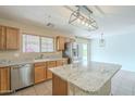 Kitchen island with granite countertop and wooden cabinets at 2665 W Goldmine Mountain Dr, San Tan Valley, AZ 85144