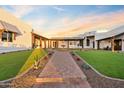 Landscaped courtyard with a fountain, brick walkway, and lush green lawn at 29441 N 64Th St, Cave Creek, AZ 85331