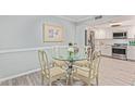 Bright dining area with glass table and four chairs, adjacent to kitchen at 4200 N Miller Rd # 309, Scottsdale, AZ 85251