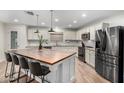 Modern kitchen featuring an island, stainless steel appliances, and hardwood floors at 19641 E Emperor Blvd, Queen Creek, AZ 85142