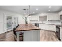Updated kitchen features white cabinets, large island, and access to backyard at 19641 E Emperor Blvd, Queen Creek, AZ 85142