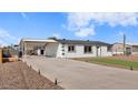 Newly renovated single story home with artificial turf and carport at 306 N Hawes Rd, Mesa, AZ 85207