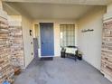 Inviting front entry with decorative door, welcome sign, and sitting area at 8605 W Carole Ln, Glendale, AZ 85305