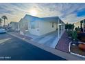 Light-colored manufactured home with carport and landscaping at 9333 E University Dr # 51, Mesa, AZ 85207