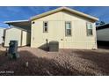 Rear view of manufactured home with shed and AC unit at 9333 E University Dr # 51, Mesa, AZ 85207