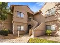 Exterior view of a two-story condo building with stairs leading to the entrance at 15050 N Thompson Peak Pkwy # 2053, Scottsdale, AZ 85260