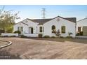 Front view of a white house with a tile roof and desert landscaping at 23628 N 105Th Ln, Peoria, AZ 85383