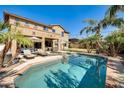 Inviting backyard oasis featuring a sparkling pool, lounge chairs, and palm trees at 3937 E Taurus Pl, Chandler, AZ 85249