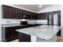 Spacious kitchen with dark cabinets and granite countertops at 738 W Jardin Dr, Casa Grande, AZ 85122