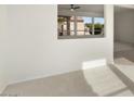 Living room with view to backyard through a window at 15744 W Clear Canyon Dr, Surprise, AZ 85374