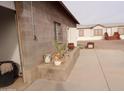 Side yard with gravel, a concrete patio, and plants at 30138 W Roosevelt St, Buckeye, AZ 85396