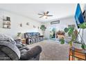 Bright living room featuring sliding glass doors opening to the backyard at 3111 N 309Th Dr, Buckeye, AZ 85396