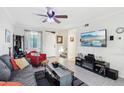 Bright living room with comfy seating, large TV, and ceiling fan at 5106 N 17Th Ave # 11, Phoenix, AZ 85015