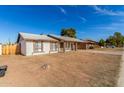 Front view of a single-story house with a yard at 8924 W Mackenzie Dr, Phoenix, AZ 85037