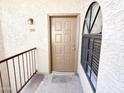 Condo entrance with a brown door and arched window at 930 N Mesa Dr # 2034, Mesa, AZ 85201