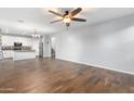 Open concept living room with hardwood floors and kitchen views at 9814 E Palladium Dr, Mesa, AZ 85212