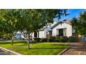 Beautiful farmhouse-style home with a landscaped lawn and mature trees at 17870 E Appaloosa Dr, Queen Creek, AZ 85142