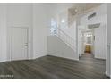 Open living area with laminate floors and staircase to loft at 19601 N 7Th St # 2026, Phoenix, AZ 85024
