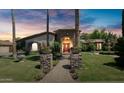 Elegant home exterior at dusk, showcasing stone and landscaping at 4528 E Hobart St, Mesa, AZ 85205