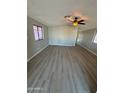 Living room featuring gray vinyl plank flooring and ceiling fan at 652 S Ellsworth Rd # 127, Mesa, AZ 85208