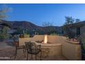 Peaceful backyard patio with fire pit and mountain views at 11233 E Butherus Dr, Scottsdale, AZ 85255
