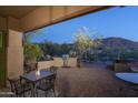 Outdoor kitchen and dining area with mountain views at 11233 E Butherus Dr, Scottsdale, AZ 85255