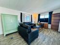 Living room with dark leather couches and wood-look floors at 305 S Val Vista Dr # 204, Mesa, AZ 85204
