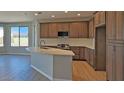 Modern kitchen with island, stainless steel appliances, and hardwood floors at 5625 W Bullhead Rd, Eloy, AZ 85131