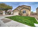Two-story house with a large yard, driveway, and attached garage at 5659 S 239Th Dr, Buckeye, AZ 85326