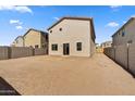 Large backyard with block wall and new construction homes at 7410 W Rovey Ave, Glendale, AZ 85303